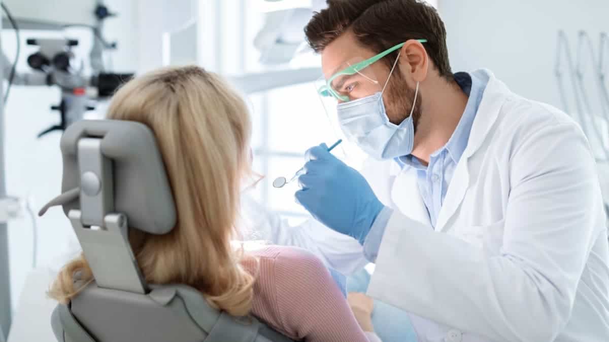 Patient receiving professional teeth whitening with a laser device Basildon